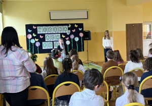 Dziewczynka recytuje wiersz przed publicznością.