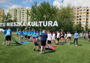 Uczniowie wykonują zadania sportowe podczas finału projektu ekologiczno-sportowego w Warszawie.